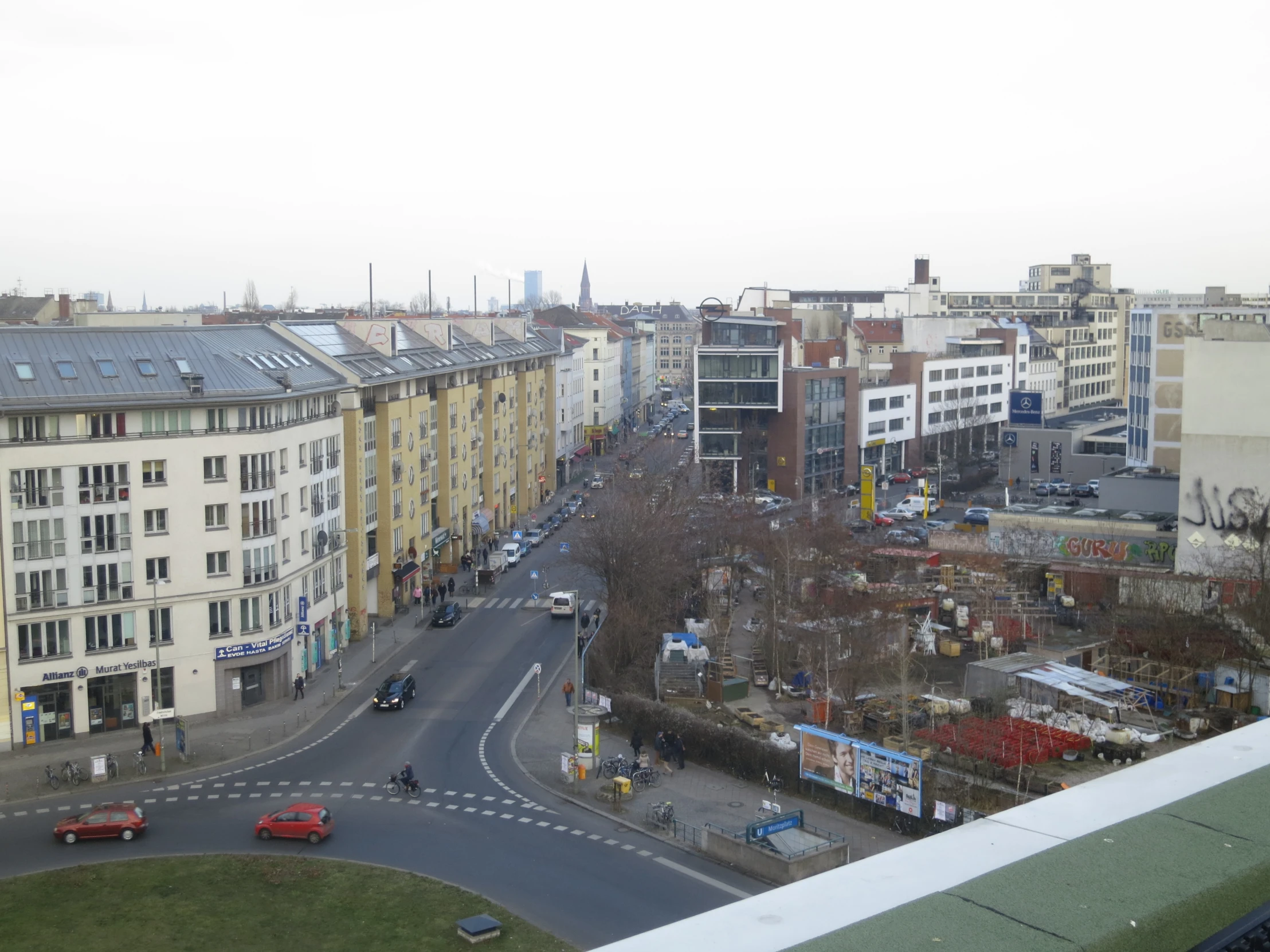 the view from the top of the tall buildings shows several cars