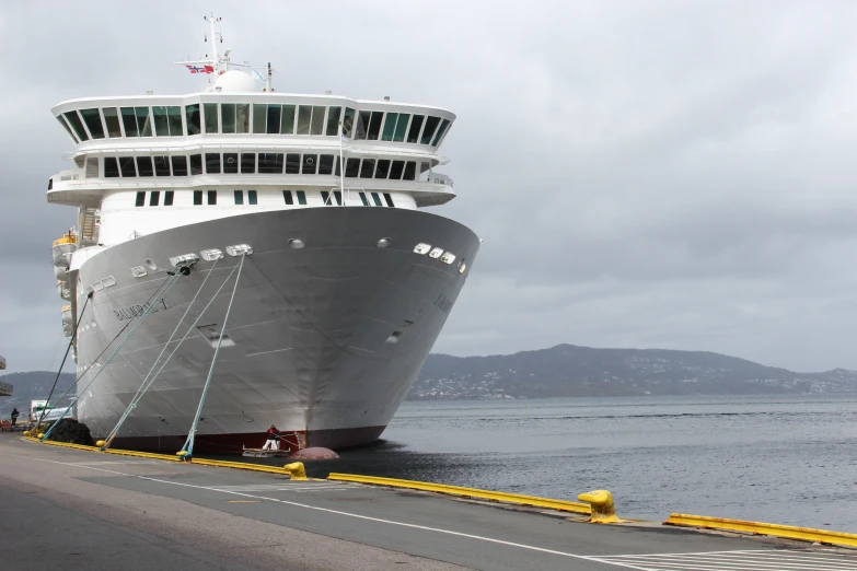 the large cruise ship is docked near the shore