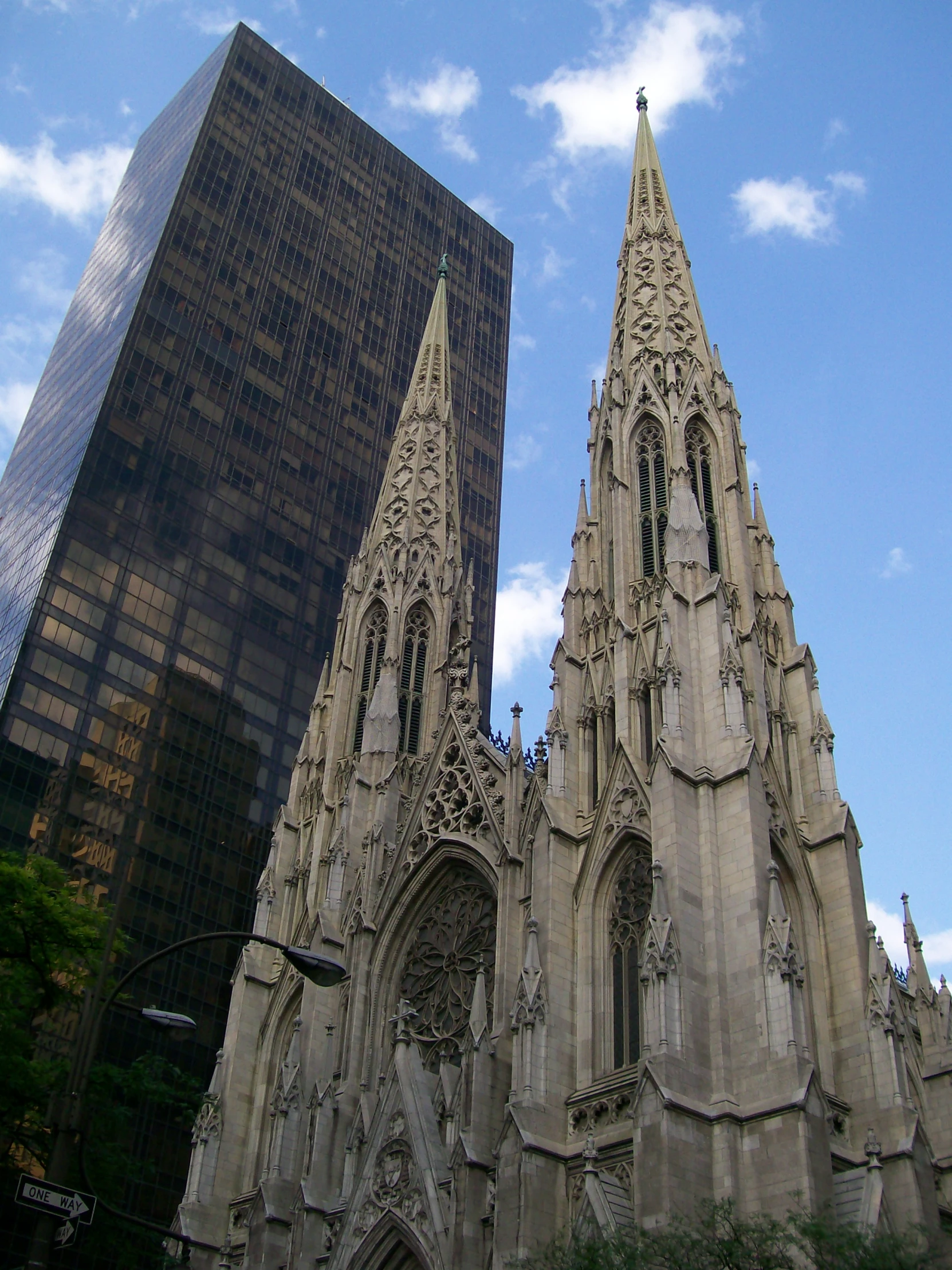 two very tall buildings next to each other in front of a blue sky