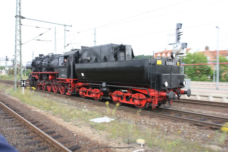 there is an old train engine on the tracks