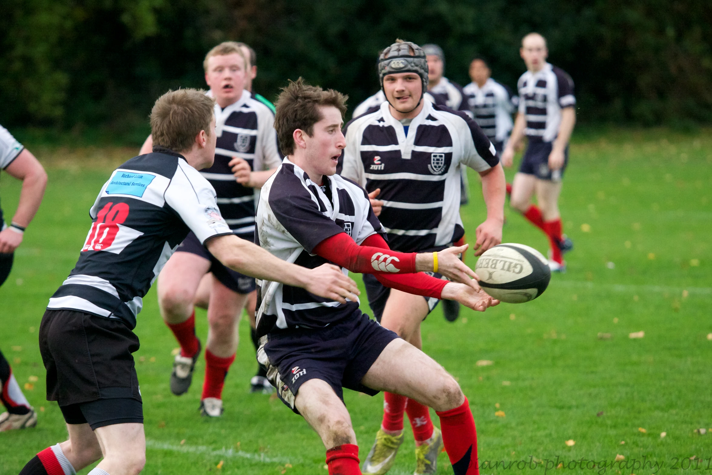 a man in a striped shirt is holding a ball