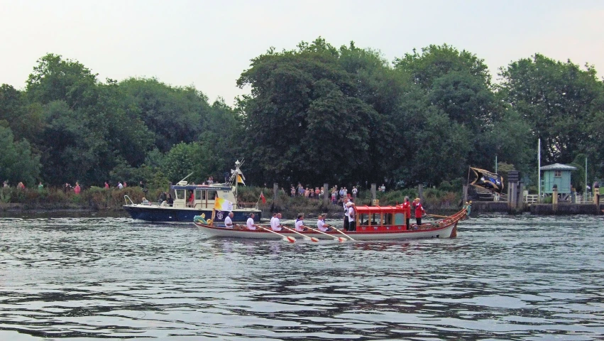 small red boats floating on a lake surrounded by greenery