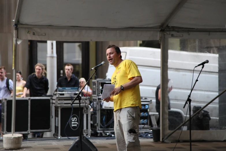 a man is standing on a stage in front of an audience