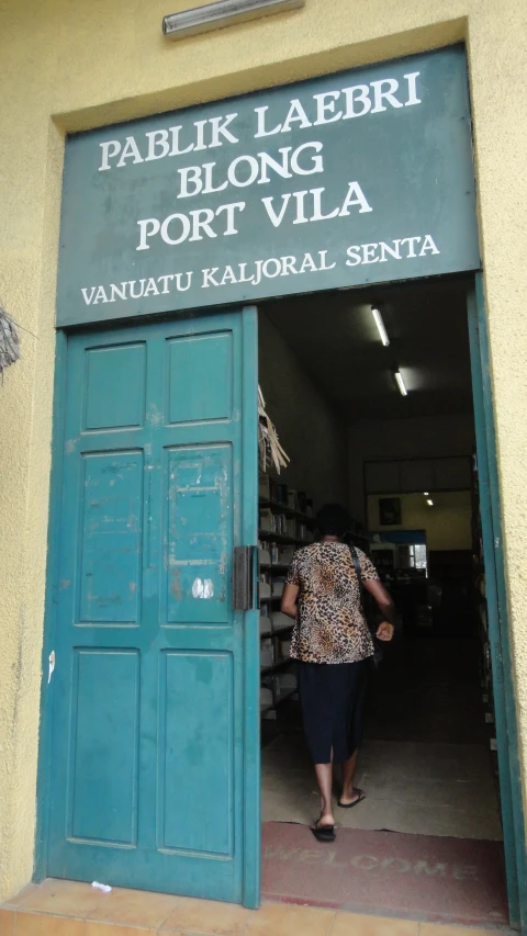 a person stepping in into a building with many books