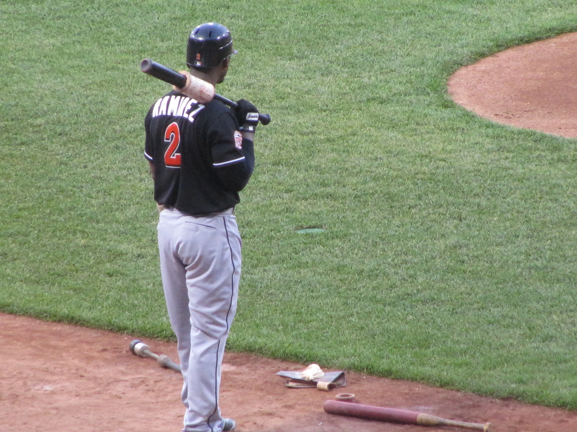 a baseball player standing at home base holding his bat