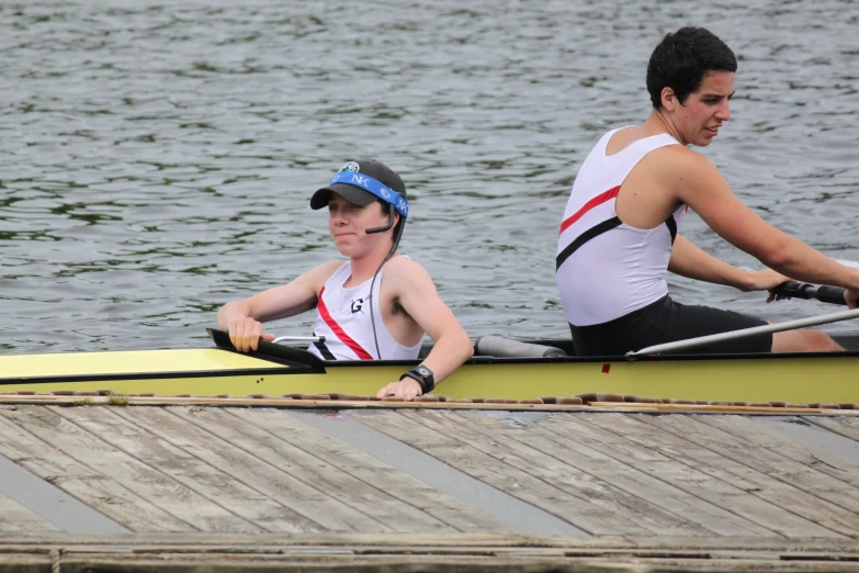 two men riding in canoes across a body of water