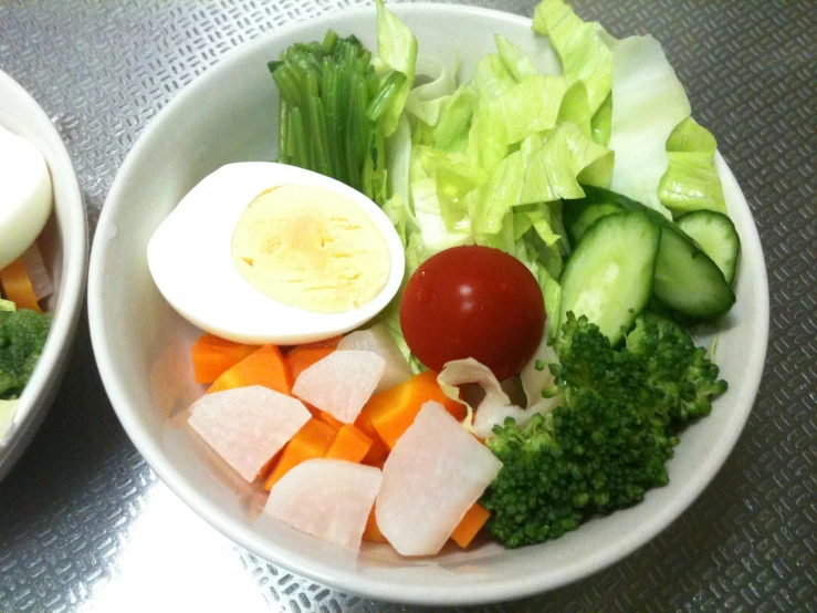 a bowl filled with many different foods sitting on top of a table