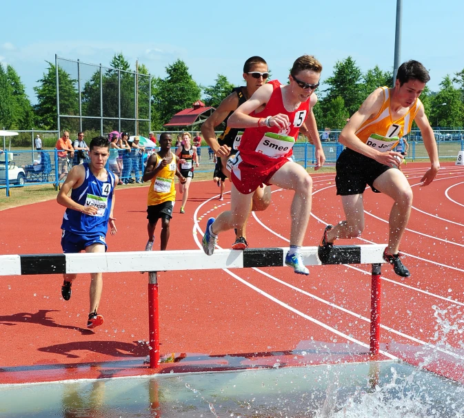 people are competing in a track race with water