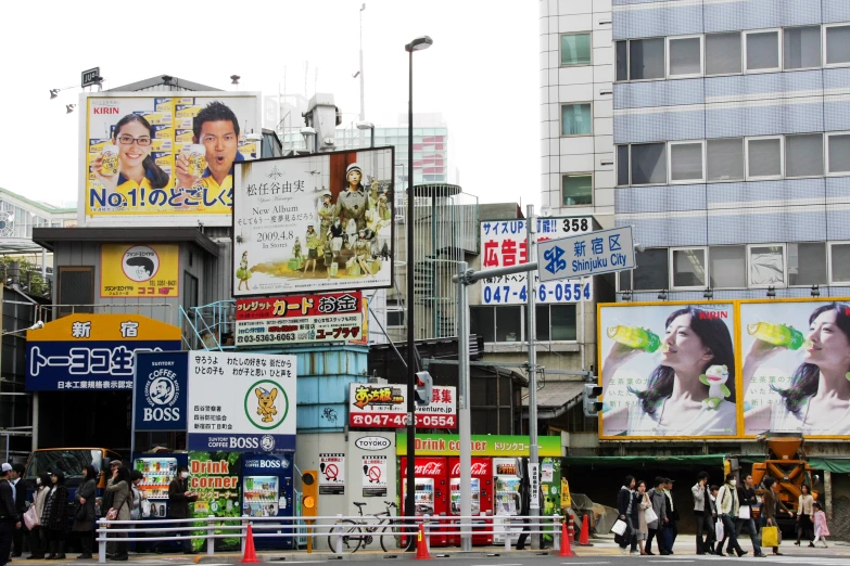 a street corner with many billboards and advertits on it