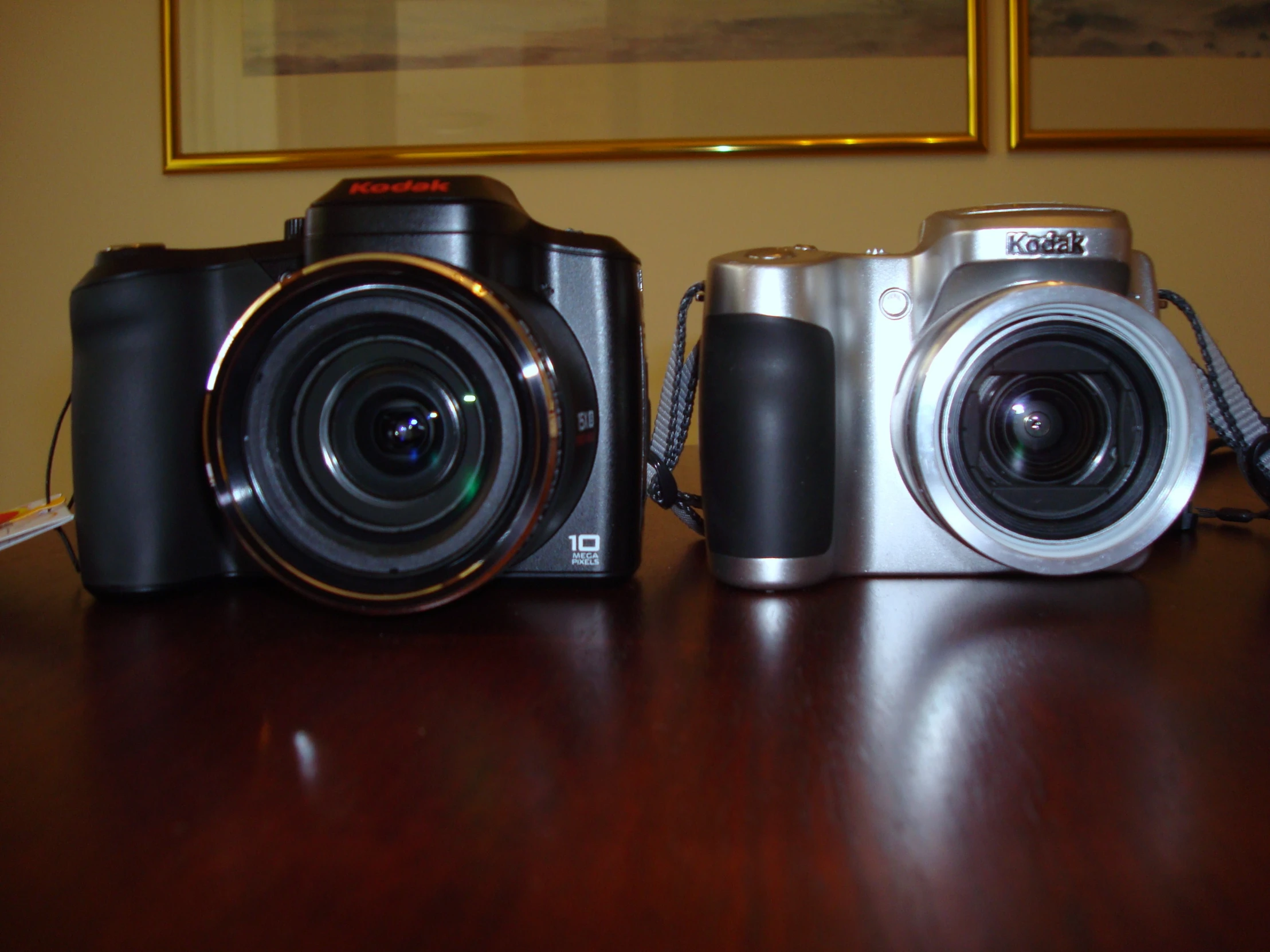 a close up of three different cameras on a table