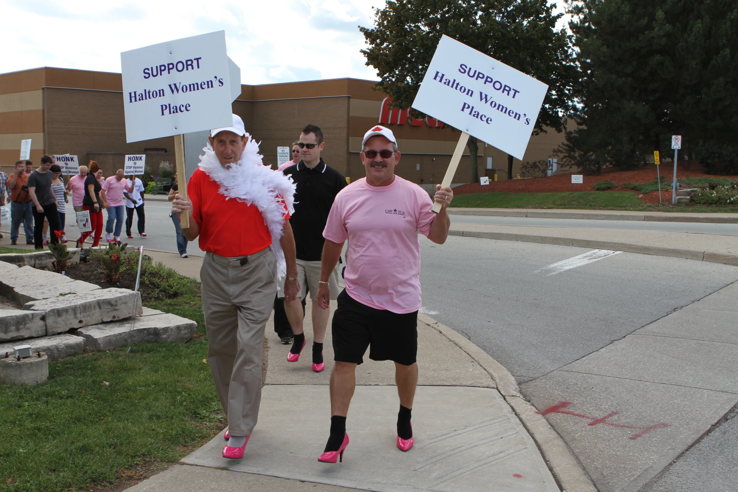 two men in funny costumes are holding signs