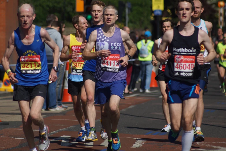 marathon runners racing in a city street on a sunny day