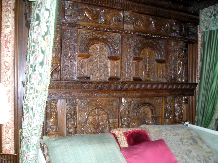 a wood paneled bedroom with a window covered bed