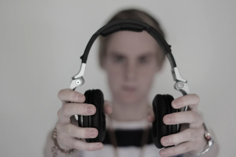 the woman with two headphones is covering her face