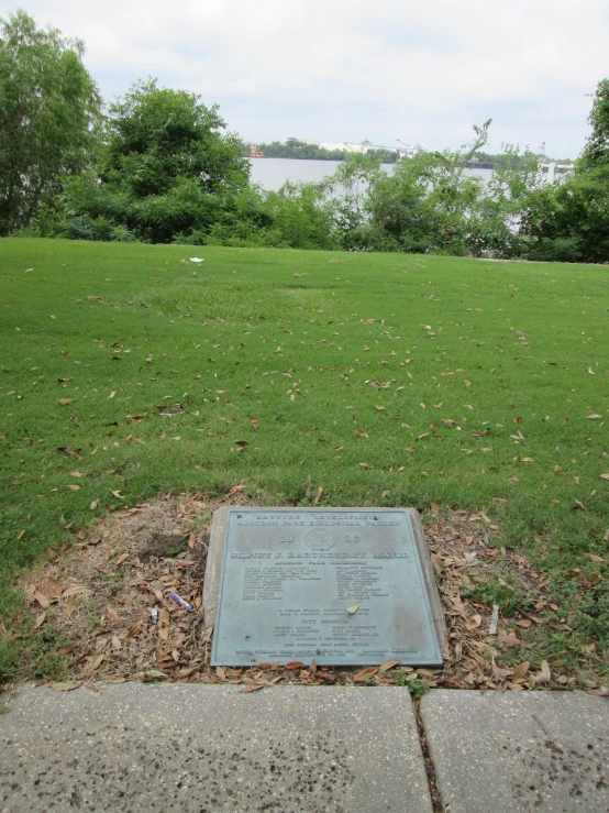 there is a stone plaque sitting on the sidewalk