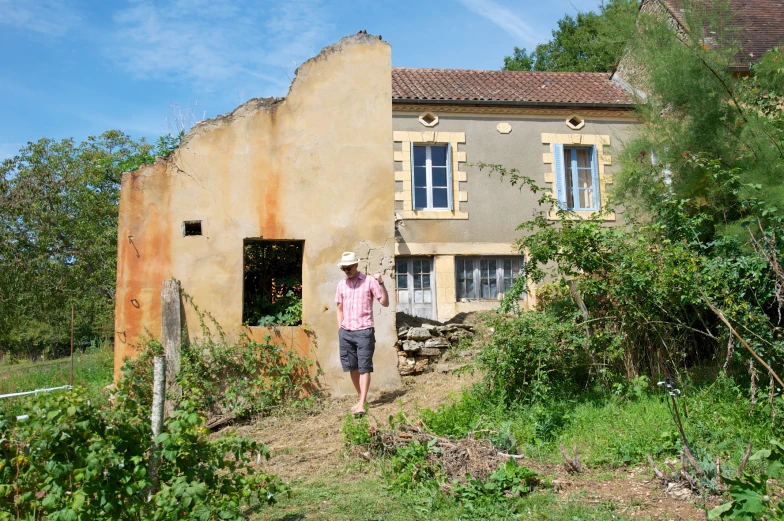 a man in a straw hat and a house with a door