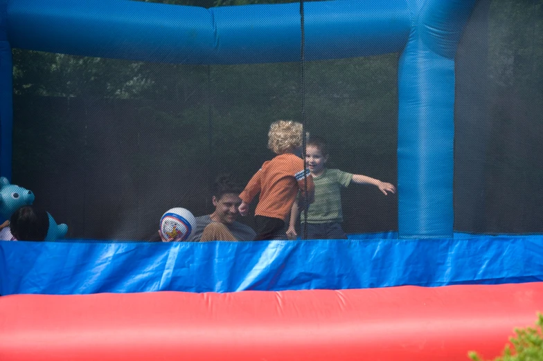 there are two s walking in a bounce castle