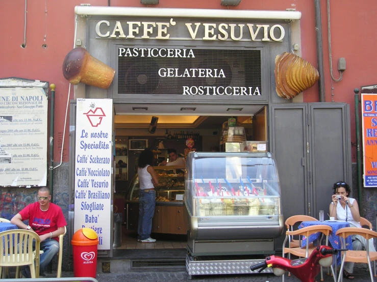 a person that is standing at the entrance of a restaurant