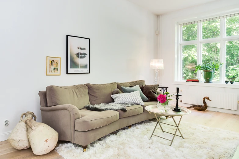 living room scene with couches and windows with birds