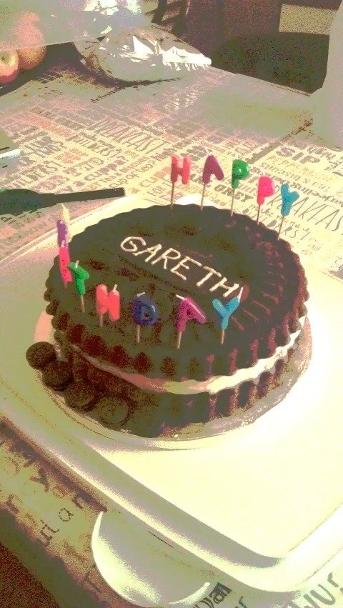 a cake with candles is sitting on the counter top