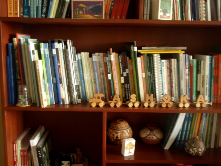 the books are being displayed on a book shelf