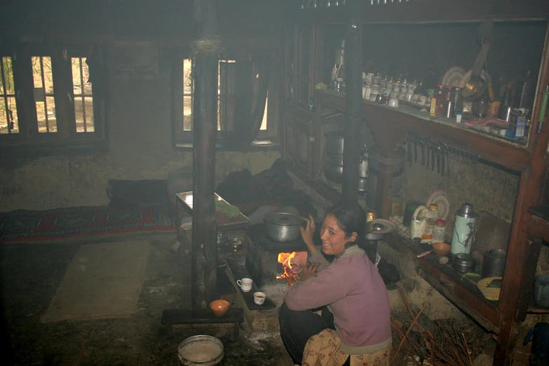 a woman is preparing a meal in a wooden cabin