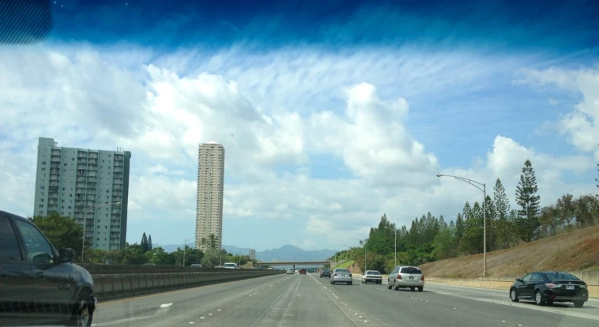 cars are riding down a freeway in the day