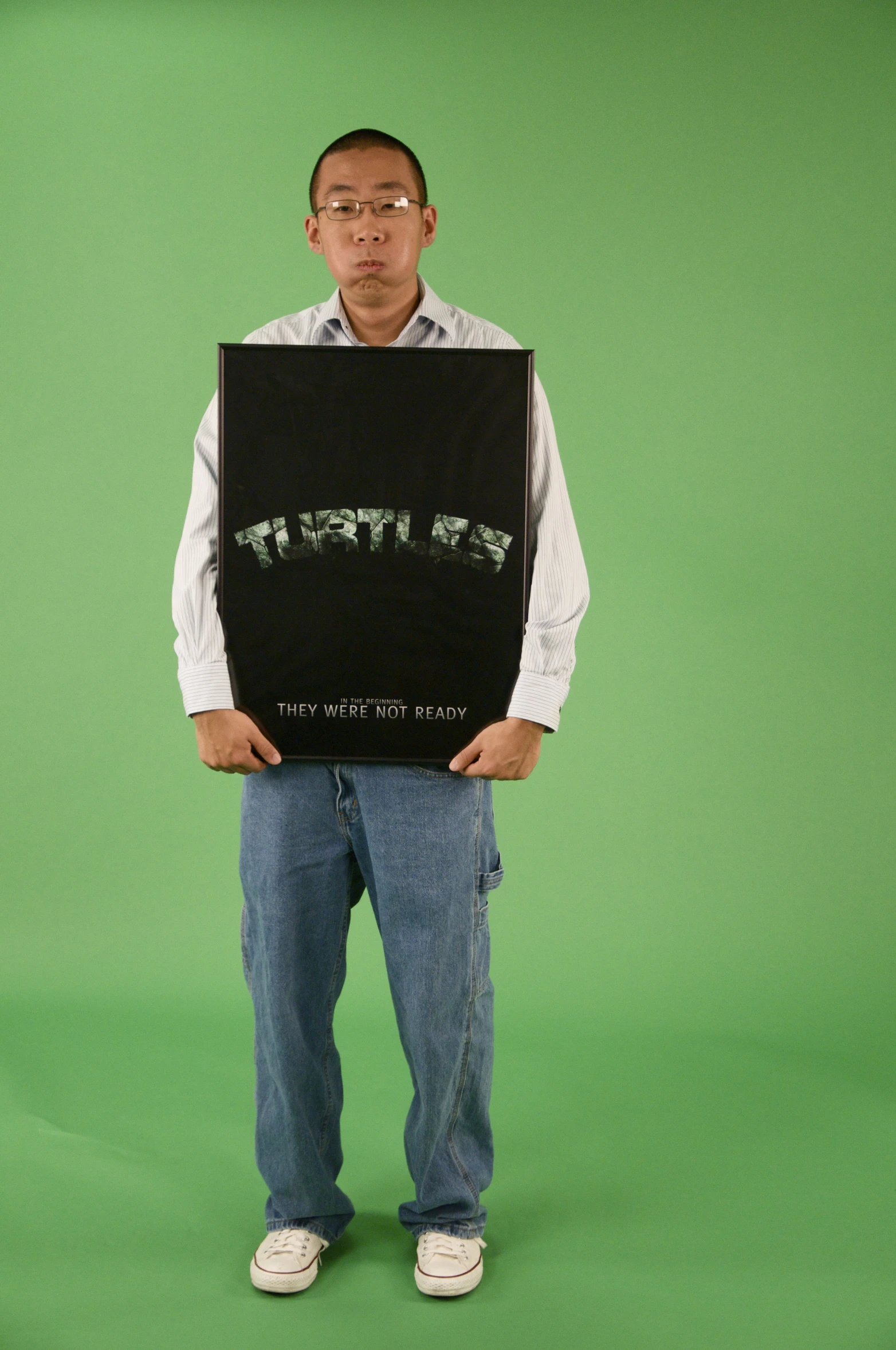 the man is holding a poster with words written in it