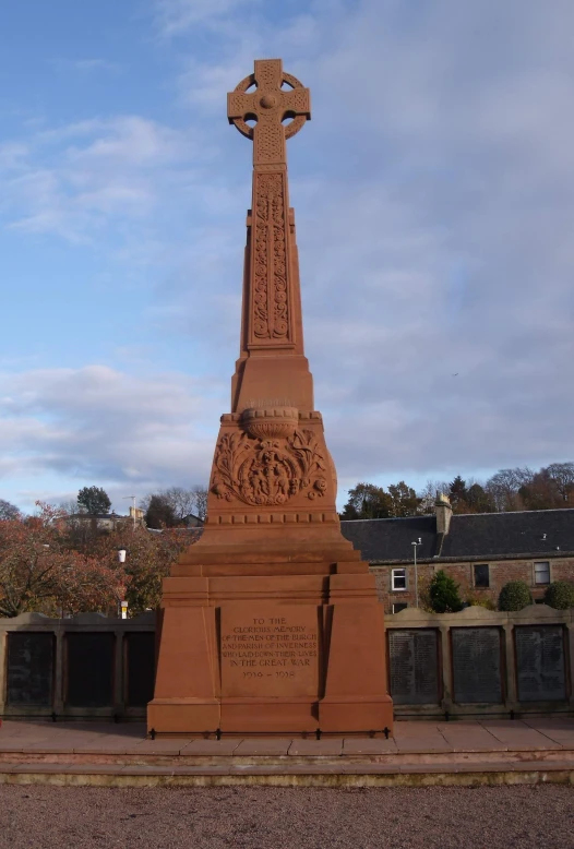 a brick monument with a cross on top