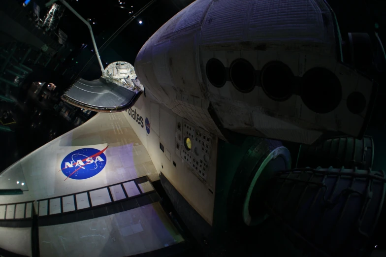 a nasa vehicle and spacecraft on display in an exhibit