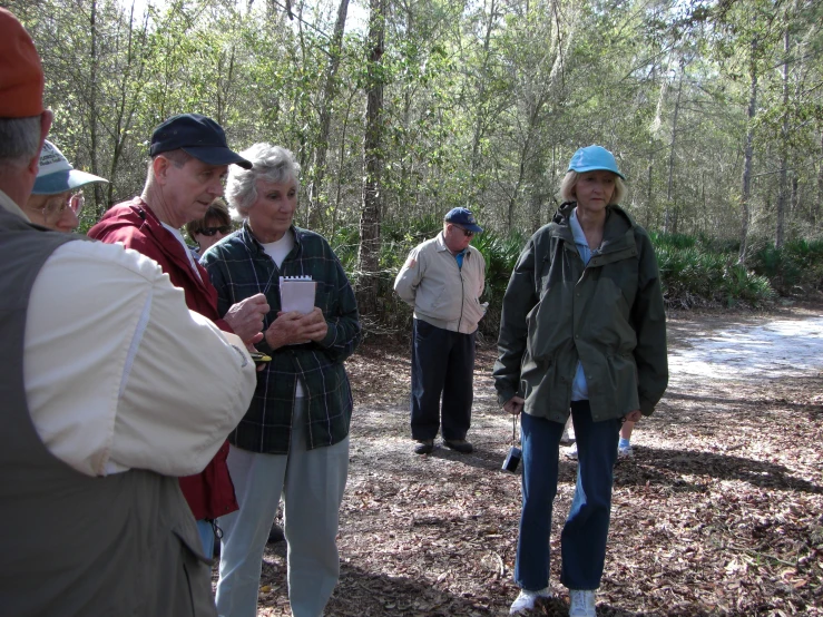 a group of people standing in the woods