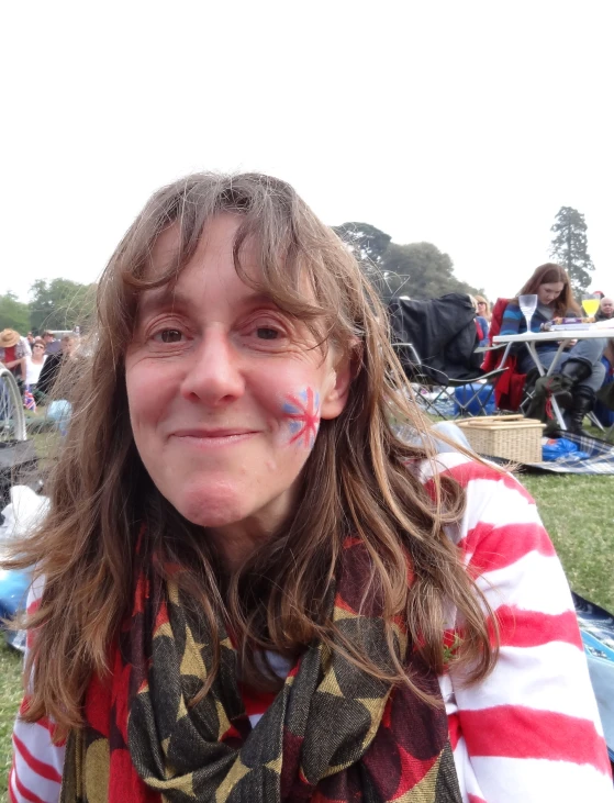 woman in striped top and scarf in grassy area