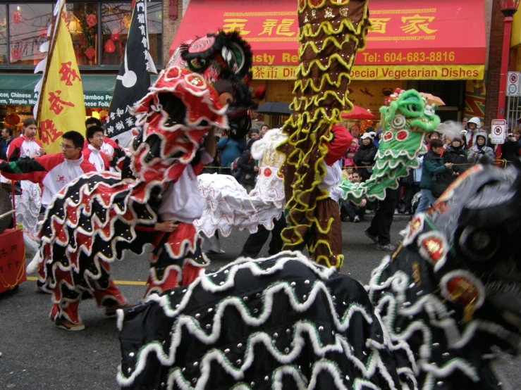 a large parade with people in costume walking down the street