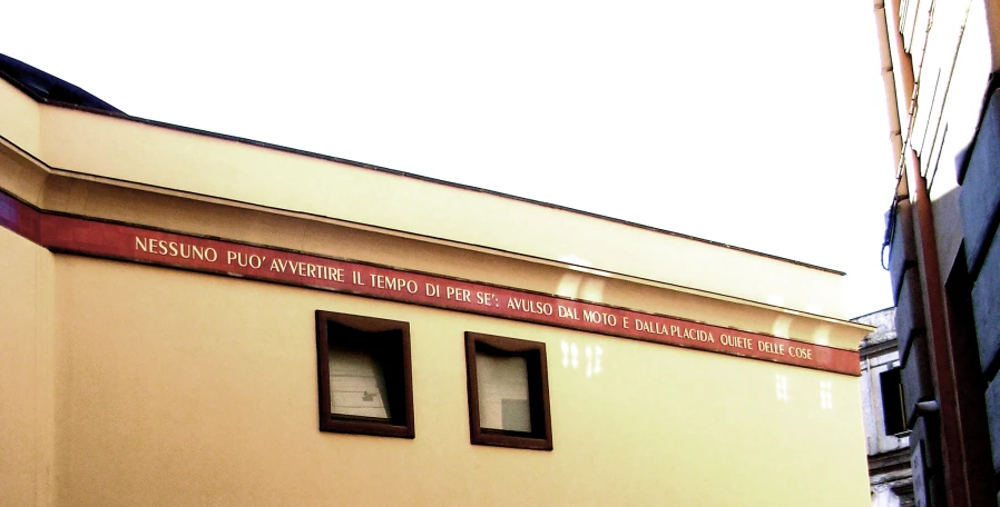 a yellow building with two windows and the words the national liry on it