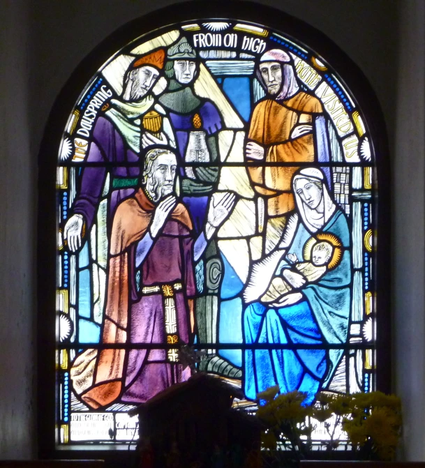 the saint is surrounded by his people in a stained glass window