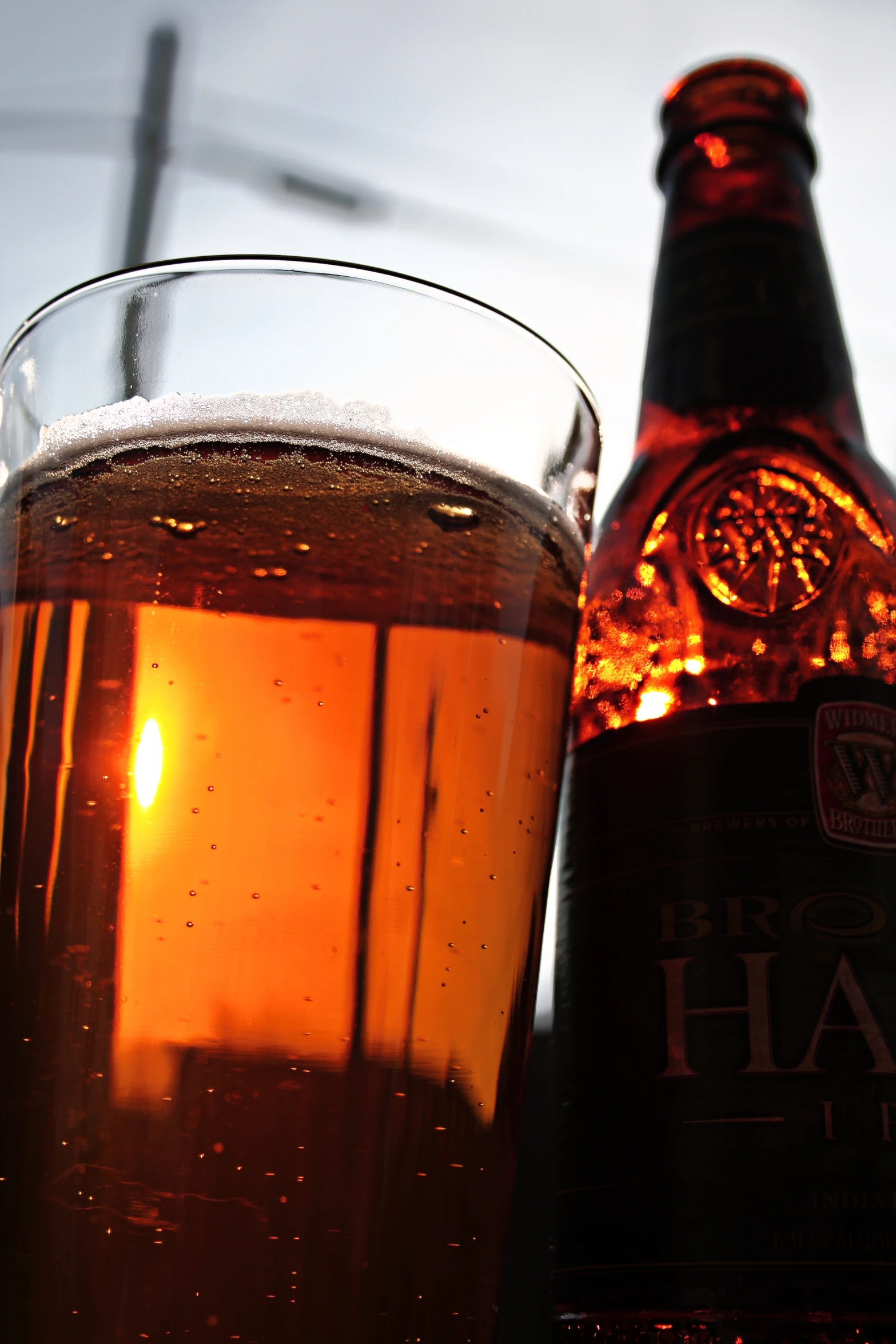 a beverage next to a bottle of beer on a table