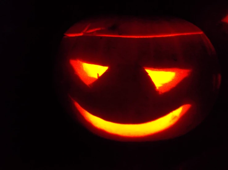 a carved pumpkin with a glowing face