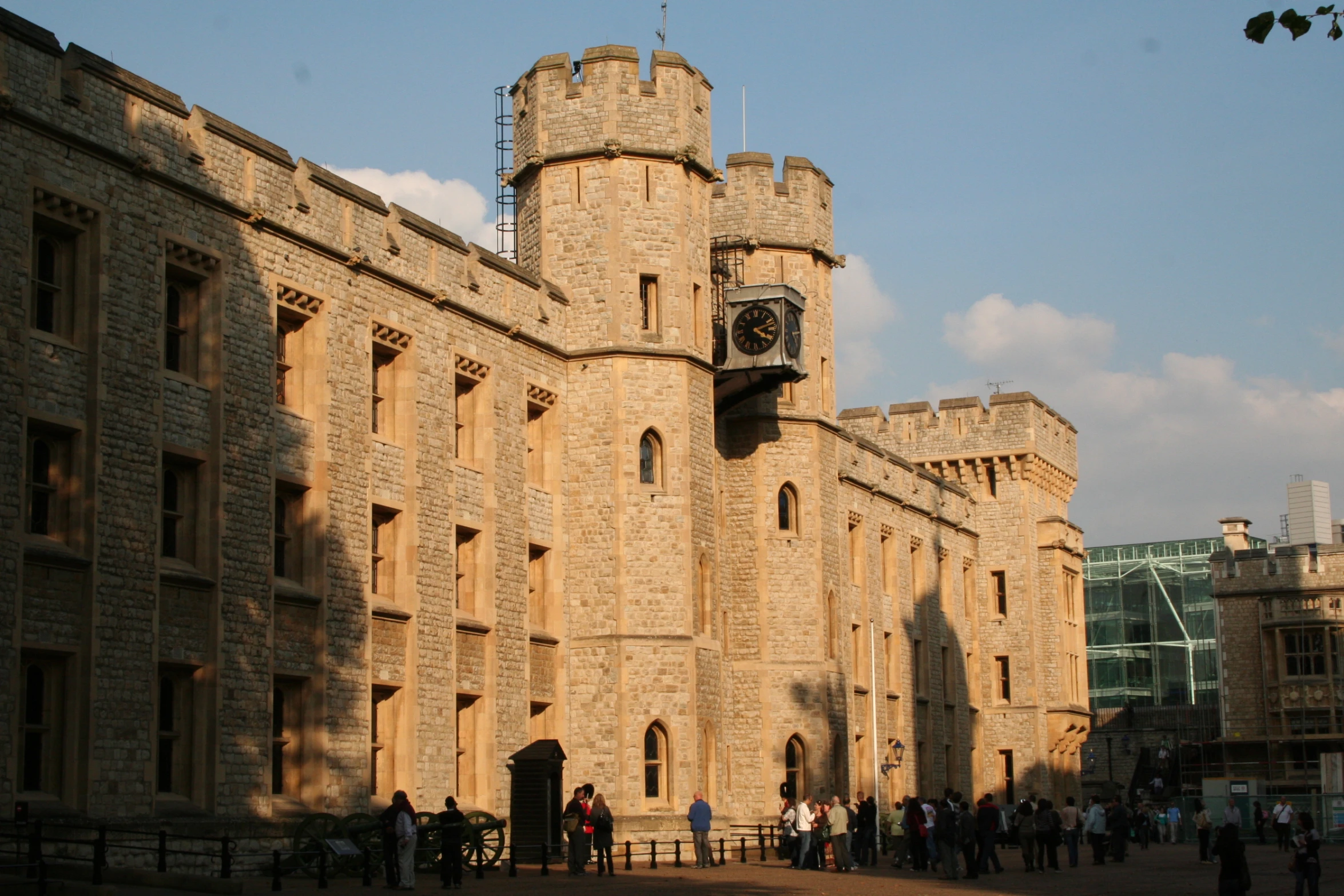 this is an old stone building with people on the walkway