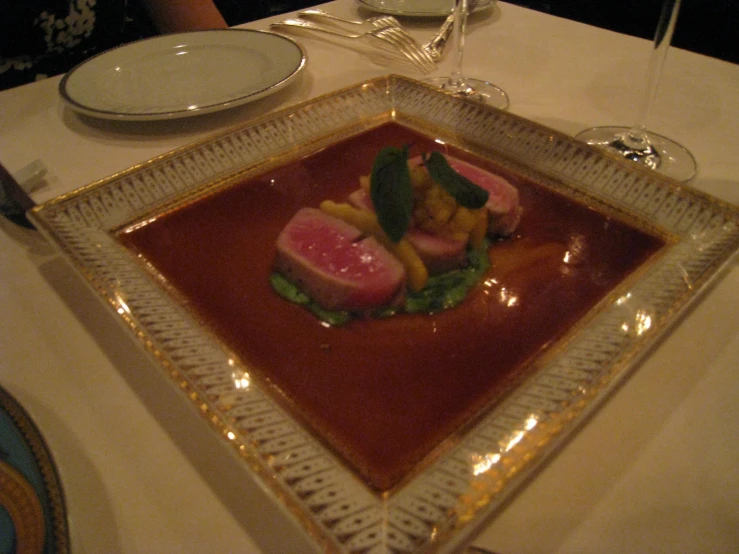 the glass tray is filled with food and sauce