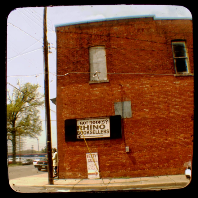 two signs on the side of a brick building