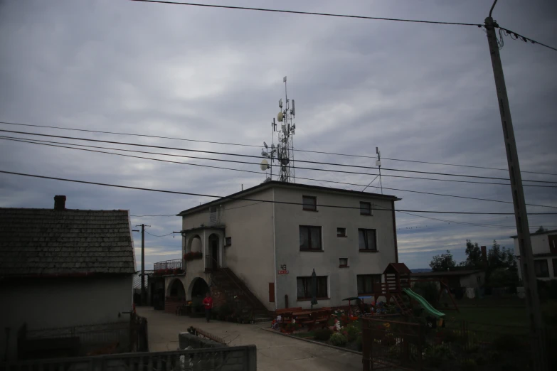 a house that has a tower and weather vane on the roof