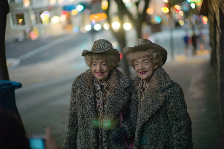 the two woman are posing for a po