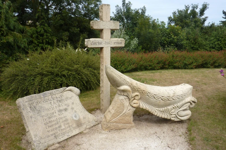 a stone statue of an angel holding the cross