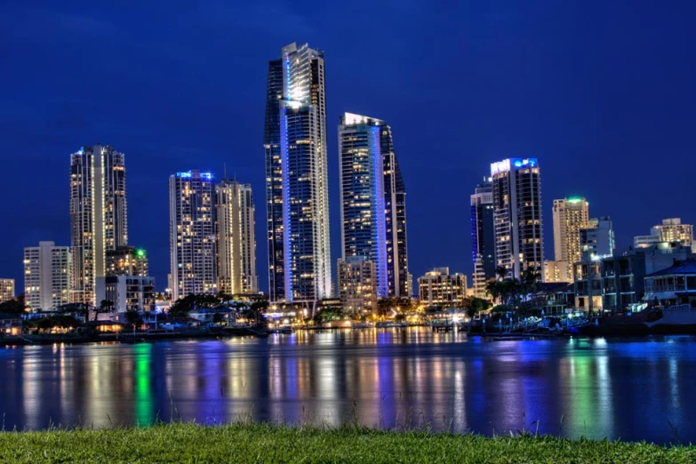 a lake that has some lights on in the buildings