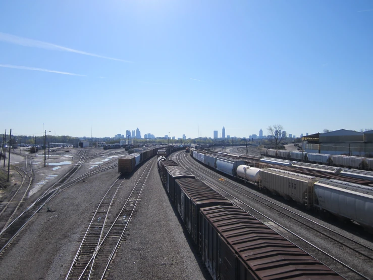 several trains that are pulling freight cars and other cars