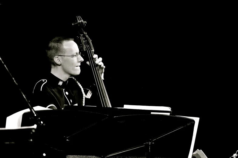 a young man playing his bass on a stage