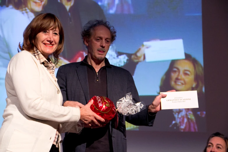 man and woman are receiving an award at a competition