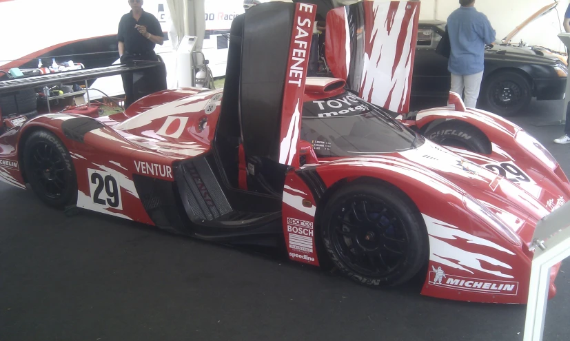 the race car is decorated in red and white