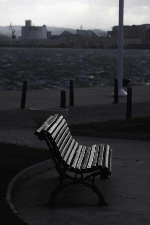 a bench on the ground next to the water