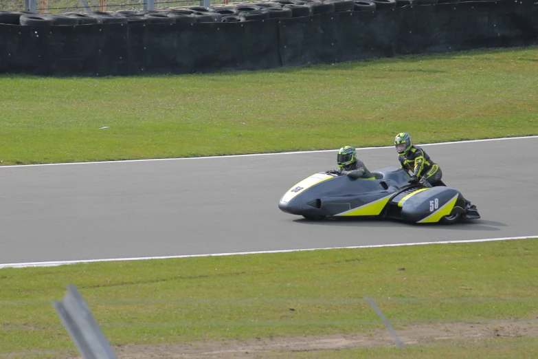 two people are riding on a small motorcycle